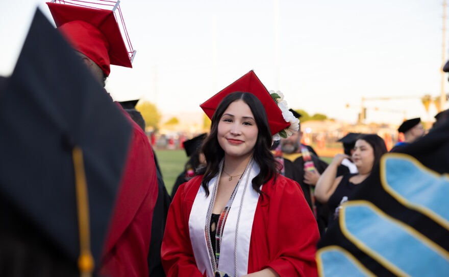 Graduates had a variety of sashes and cords to denote their accomplishments. This student has an AWC Honors sash and a sash from La Cosecha, a yearly event celebrating students who overcame great obstacles to earn their degrees. The silver cord represents high academic achievement.