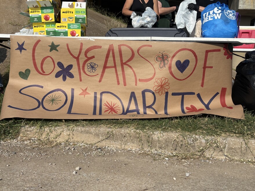 A sign displaying, "Six years of solidarity." The sign was made by Tulsa Food Not Bomb volunteers to celebrate their sixth-year in protest via sharing food and resources.