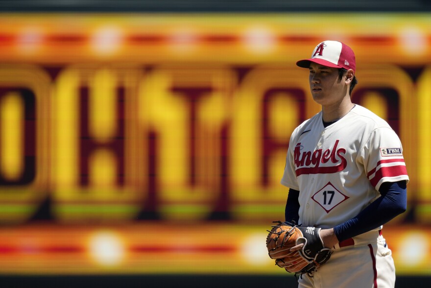 Los Angeles Angels starting pitcher Shohei Ohtani gets set to pitch during the first inning in the first baseball game of a doubleheader against the Cincinnati Reds on Wednesday, in Anaheim, Calif., before an MRI exam revealed his elbow tendon tear.
