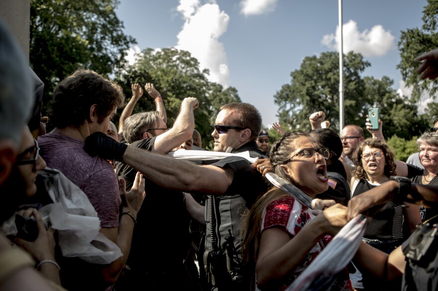 Protesters and the police struggle in August 2017 after officers tore down banners that demonstrators attempted to hang on a statue of Nathan Bedford Forrest in Memphis.