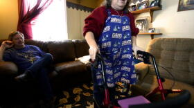 Rick King watches his wife, Cheryl, use a walker to get into the kitchen of their home in East Syracuse.