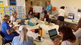 Volunteers at a former Democratic candidate David Holden's headquarters on Thursday try to connect provisional voters with their ballots. 