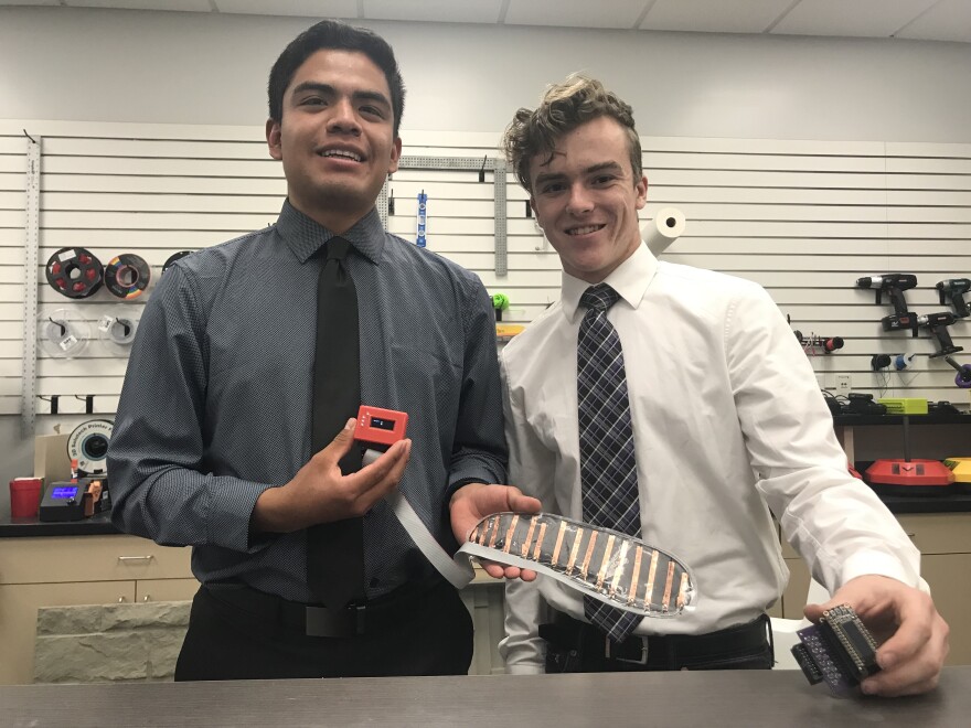 Derek Colon (left) and Nicholas Anderson hold their Right 25 prototype, a smart insole designed to help with foot rehab.