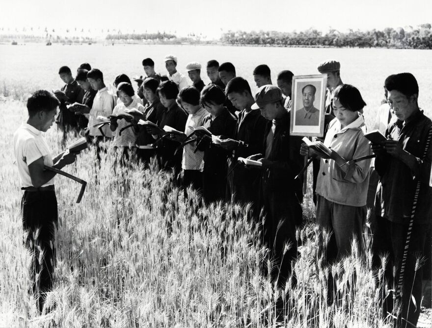 Prior to starting work in a field, young people read some of "Mao Zedong Thoughts" together in Nanshanglo administrative district on July 7, 1967. This is probably a propaganda picture set up during the "Great Proletarian Cultural Revolution."