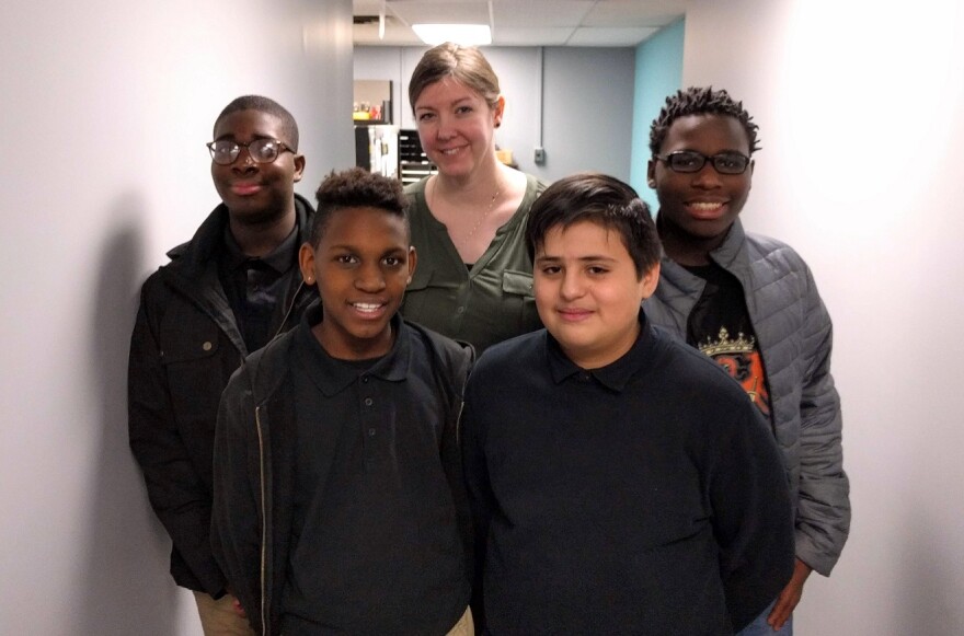 Coronado Middle School students (from left) Uhunoma Amayo, Daleshone Sharkey, Carlos Jimenez Reyes and DaQuon Cheadle designed an experiment to be conducted on the International Space Station. Erin Morley, center, helped guide them through the process.