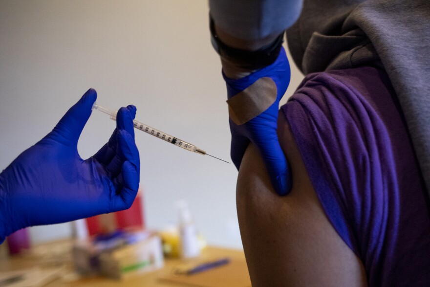 A nurse administers the Pfizer-BioNTech vaccine during a Confederated Salish and Kootenai vaccination clinic at the KwaTaqNuk Resort in Polson, Montana, on March 30, 2021. (Tailyr Irvine for KHN)