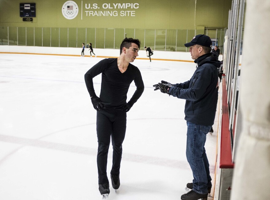 Max Aaron talks with his coach, Tom Zakrajsek, during practice at the World Arena Ice Hall in Colorado Springs.