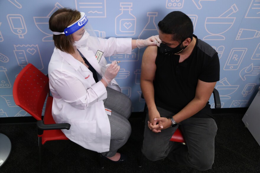 Pharmacist administers a flu shot