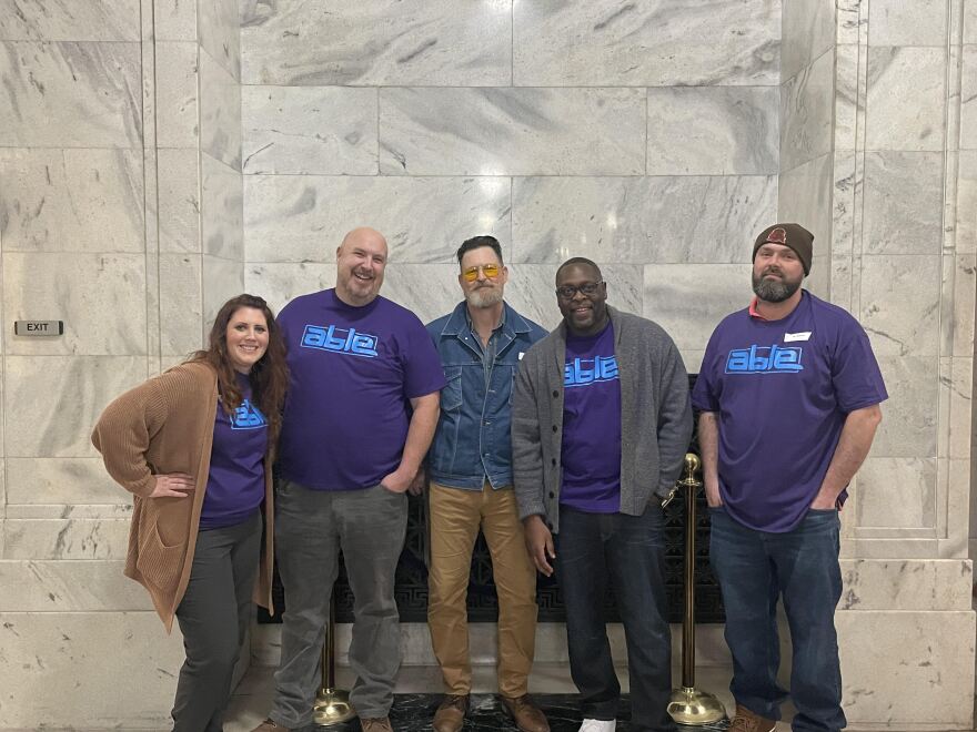 Organizers and volunteers with ABLE (Advocacy Based on Lived Experience) pose together at the Kentucky Capitol in Frankfort.