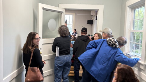People spilled out of a select board public comment session on a potential data center in Bow, New Hampshire.