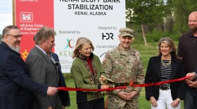 U.S. Sen. Lisa Murkowski (center) cuts the ribbon during a ceremony to celebrate the start of construction on the Kenai bluff stabilization project on Monday, June 10, 2024 in Kenai, Alaska.