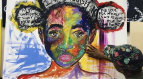Charlotte artist Whitney Austin works on one of her paintings.