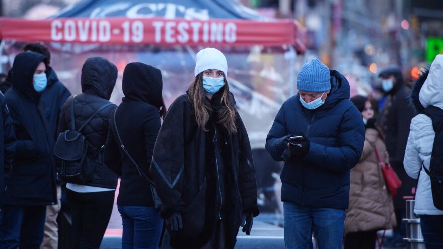 People wait at a street-side testing booth in New York's Times Square on Monday.