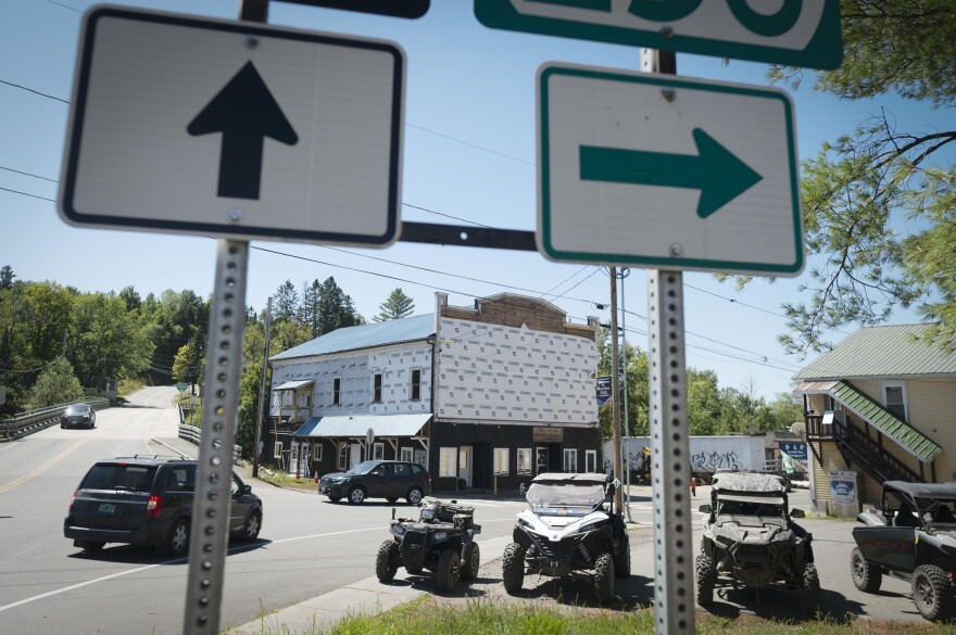 A building is viewed through the space between roadsign posts