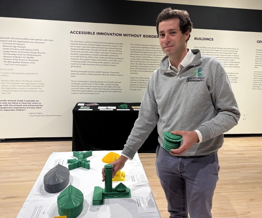 Director of Braille Production and Accessible Innovation at Clovernook, Sam Foulkes. He points to a model of a building in Nairobi.