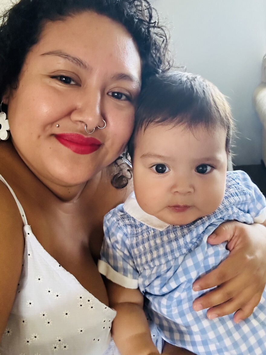 Zuleyma Castrejón Salinas poses with her son, who turns one this month. Much of the art featured in her exhibition was created during and after her pregnancy with him.