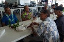 At a family event hosted by the Wat Thammarattanaram, Laotian men eat crawfish served alongside traditional Laotian and Vietnamese dishes.