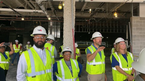 Little Rock School District officials, including Pinnacle View Middle School Principal Takecia Campbell (second from left) and Don Roberts Elementary Principal Steven Helmick (second from right) survey the construction site of what will be Pinnacle View High School on Tuesday, Nov. 18, 2025.