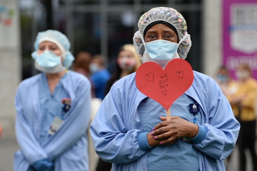 Pamelia Bogle, an anesthesia technician at Hartford Hospital, holds a reassuring heart sign at a celebration for National Nurses Week at Hartford Hospital.