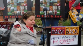 Danielle Bustos, who has been utilizing self-directed developmental disability care since 2015, speaks against budget cuts to the Maryland Developmental Disabilities Administration on Thursday outside the State House in Annapolis, Md.