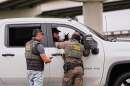 Customs and Border Patrol agents question occupants of a vehicle they pulled over, during an immigration crackdown in Kenner, La., Dec. 5, 2025. (Gerald Herbert/AP)