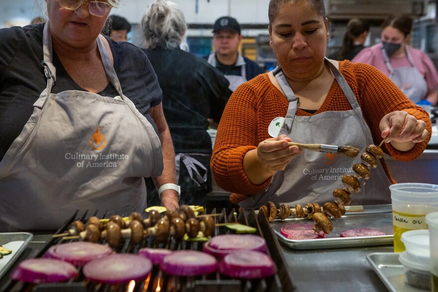 Food service workers from the San Luis Coastal Unified School District, Teresa Vigil, left, and Maria Martínez, right, learn to prepare meals at the Culinary Institute of America in Napa.