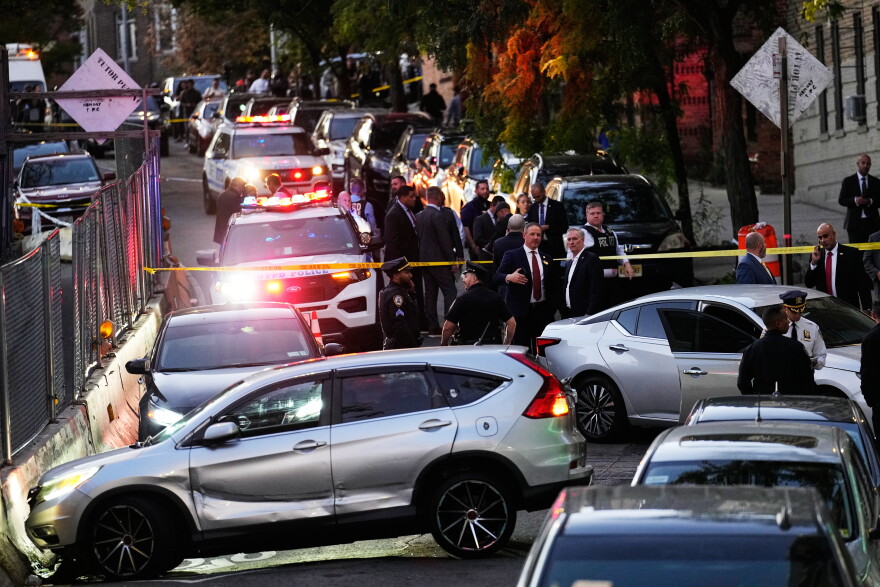 Law enforcement work the scene of a shooting Thursday, Oct. 8, 2026, in New York. (AP Photo/Seth Wenig)