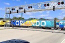 A passenger train with "Orlando" written on the side passes by a railway intersection.