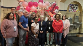 Longfellow School staff, Rock Island-Milan School District leaders and Board of Education members pose for a photo during "Dolly Day" Friday morning, Sept. 25 at the Rock Island elementary school.