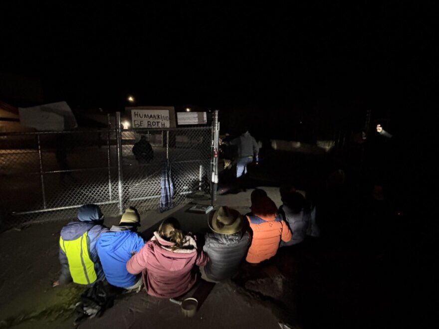 Protestors create a human chain to block the gates at a facility two children ages 12 and 15 were allegedly being held by ICE agents on the morning of Oct. 28, 2025, in Durango.