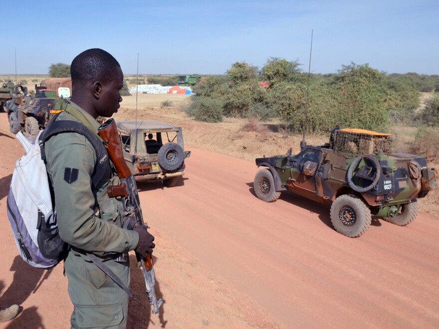 Malian soldiers watch a French military unit near Diabaly, on Jan. 23.