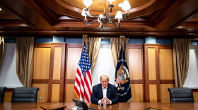 In this handout provided by The White House, President Trump participates in a phone call at Walter Reed National Military Medical Center on Oct. 4, 2020. (Tia Dufour/The White House via Getty Images)