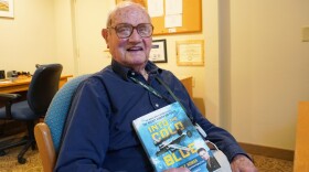 John Homan poses with his book, “Into the Cold Blue: My World War II Journeys with the Mighty Eighth Air Force.” Homan, who lives in State College, turned 100-years-old in January.