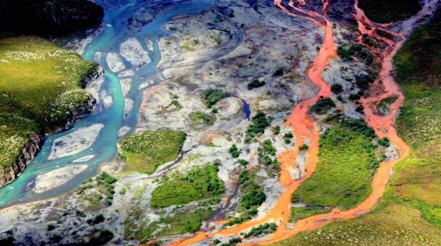 An aerial view of the rust-colored Kutuk River in Gates of the Arctic National Park in Alaska. Thawing permafrost is exposing minerals to weathering, increasing the acidity of the water, which releases metals like iron, zinc and copper.