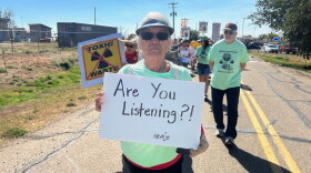 A Navajo citizen and resident of Tuba City holds a sign during the annual protest walk against the mill on Oct. 7, 2023, near White Mesa, Utah, on the Ute Mountain Ute reservation.