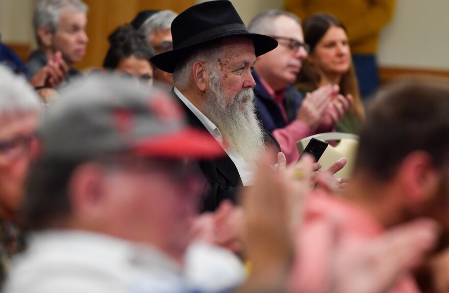 Attendees clap during Monday's presentation at the JCC in Kingston.