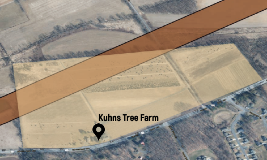 An aerial map showing a plot of land with a wide strip going through it.