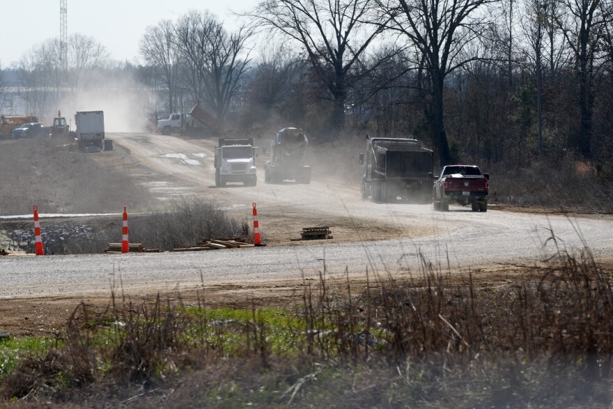 Construction traffic raises clouds of dust through the lanes that surround the construction site of a massive data center on the outskirts of Canton, Miss., Feb. 5, 2026. Area residents have complained about traffic, noise and dust in their community since construction on the complex began in 2024.