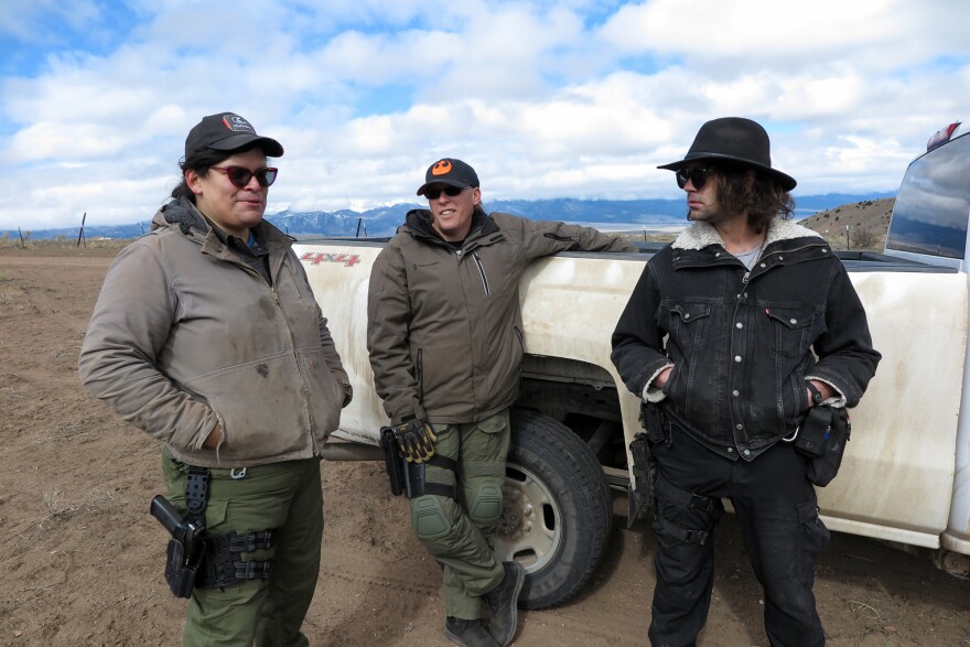 Tenacious Unicorn Ranch owners Bonnie Nelson and Penny Logue discuss heightened security measures on their property with ranch member J Stanley on April 28.