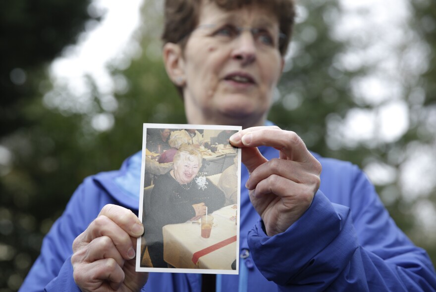 Pat Herrick holds a photo of her mom, Elaine Herrick, 89, a resident of Life Care Center who died of complications from COVID-19. The nursing home in Kirkland, Wash., was the site of one of the first coronavirus outbreaks in the United States.