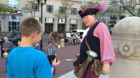 Magician Taylor Martin entertains a crowd on Monument Circle.