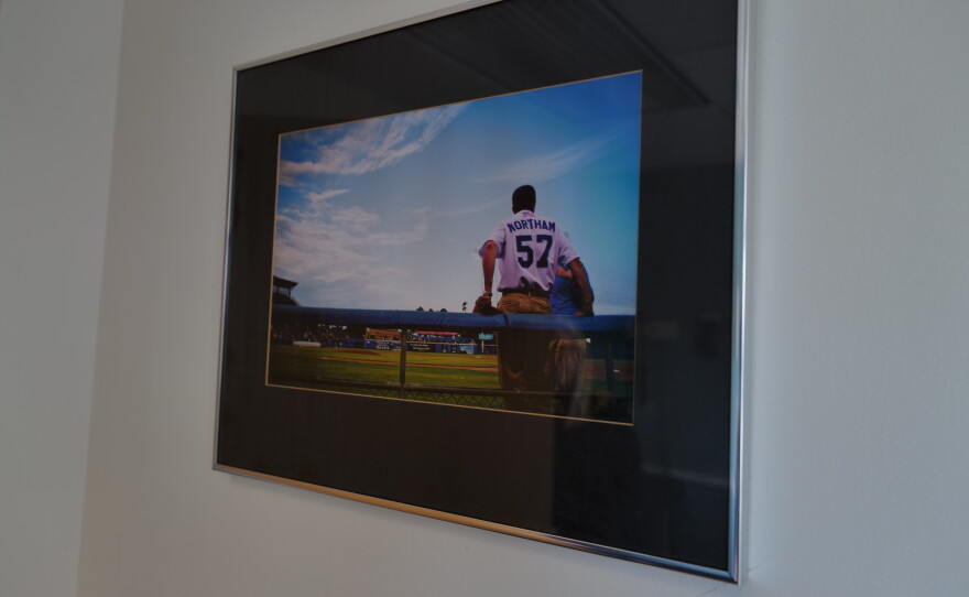 A framed photo of Ralph Northam wearing a No. 57 jersey hangs on the wall of his exam room at CHKD.