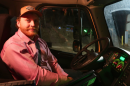 Man Sitting in driver's seat of semi-truck