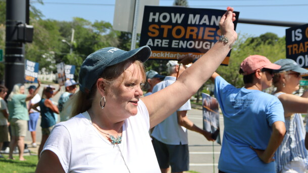 Bonnie Zampino waves to onlookers at a rally in Orleans to support former and current residents of the Community of Jesus. Zampino, who says she lived at the religious commune as a teen, tells CAI and the Provincetown Independent she was sexually abused by the group's doctor.