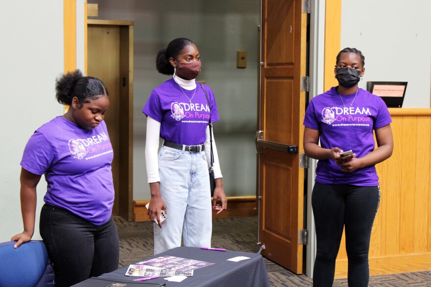 Jamia Hunt (center) talks with other girls who are part of the Dream On Purpose organization at the Alachua County Public Library Sunday, Feb. 5, 2023. “It gives young people like me an opportunity to get good activities and events outside of schools, get out of the house, learn something new,” Hunt said. (Ashleigh Lucas/WUFT News)