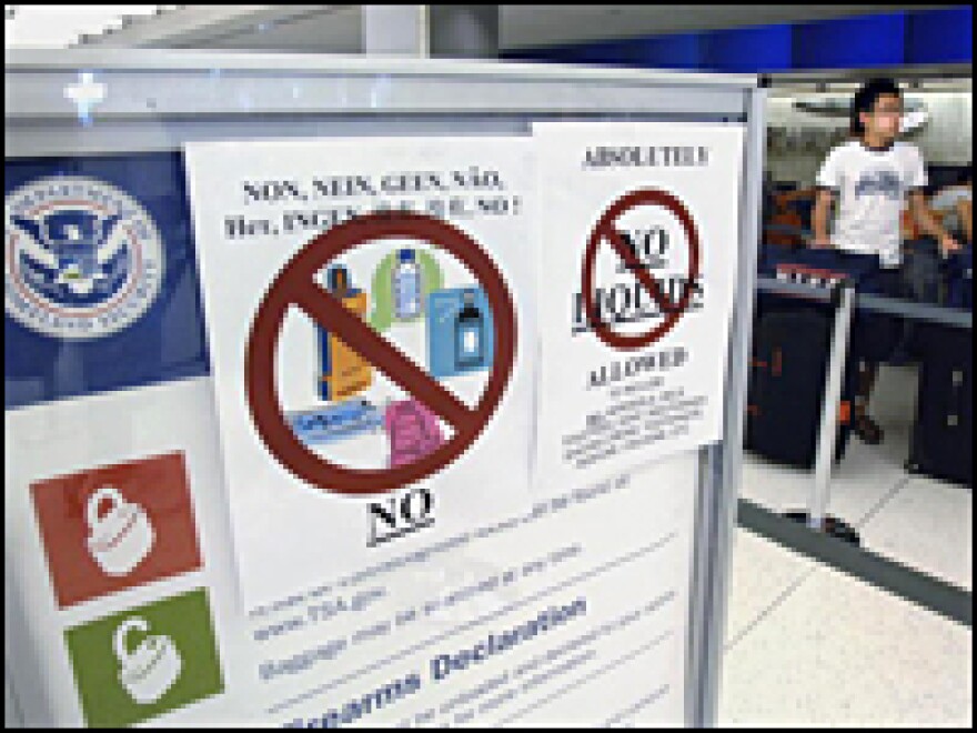 Signs indicating no liquids allowed in carry-on baggage for airline travellers are posted August 10, 2006, at the British Airways terminal at JFK International Airport in New York.