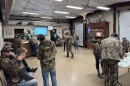 A group of hunters, all dressed in camouflage, waits in a Missouri Department of Conservation office to hear if they've been granted access to hunt ducks.