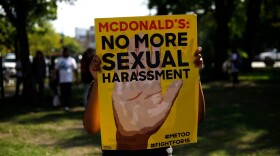 A McDonald's employee holds a sign during a protest against sexual harassment in the workplace on Sept. 18, 2018 in Chicago, Illinois.(Joshua Lott/AFP via Getty Images)