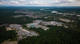 FILE - Visible deforestation from illegal mining surrounds the Quito River, near Paimado, Colombia, Sept. 23, 2024.