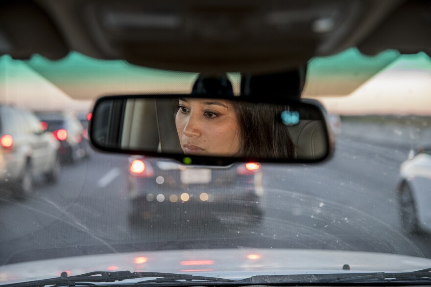 Thao Ha, who grew up in Houston and now teaches sociology at a college in California, drives in traffic as she tells NPR reporters about life in Houston's Little Saigon.